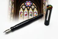 Franklin-Christoph Model 02 Intrinsic Black Cathedral fountain pen with hard acrylic cap, #6 nib before stained glass.