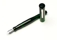 A Franklin-Christoph Model 02 Intrinsic Solid Emerald fountain pen, uncapped and resting on a white surface.