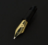 Franklin-Christoph 14K Yellow Gold S.I.G. Nib Units #6 with black grip, shown on a plain black background.