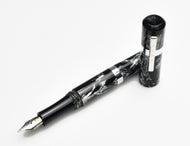 A Franklin-Christoph Model 19 Fountain Pen - Dark Room Emulsion, cap off, lies on a white surface.