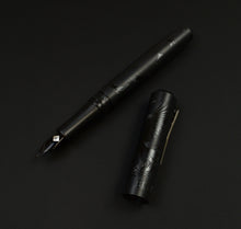 Load image into Gallery viewer, Franklin-Christoph Model 31 Black Pen Society fountain pen, engraved, cap off, displayed on a dark background.