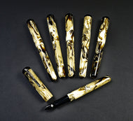 Seven Franklin-Christoph Model 31 Omnis Cold Brew SE pens with marbled patterns arranged on a dark background.