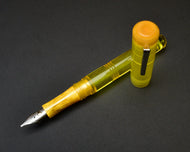 Franklin-Christoph Model 31 Omnis - Disco Lemonade, acrylic fountain pen with silver nib, capped and uncapped shown.