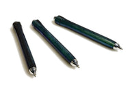 A Franklin-Christoph Model 91 Graphis pencil in Andromeda Colorshift is diagonally placed on a white background.