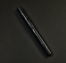 Load image into Gallery viewer, Franklin-Christoph Model 31 Black Pen Society fountain pen with engraved design rests on a dark, textured surface.