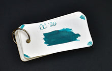 Load image into Gallery viewer, A metal ring holds cards; the top shows DC 26 Ink Bottle SE by Franklin-Christoph, inspired by the DC Pen Show.
