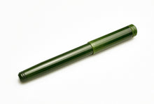 Load image into Gallery viewer, A capped Franklin-Christoph Model 20 Marietta Fountain Pen in Vintage Green rests diagonally on a white surface.
