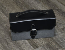Load image into Gallery viewer, The Christoph 48 Pen Case in black and grey napa leather, featuring a rectangular shape, top handle, and buckle strap.