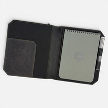 Load image into Gallery viewer, Franklin-Christoph black boot leather Command Center Padfolio with tan stitching, elastic band closure, pen slot, and grey notepad.