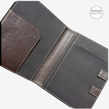 Load image into Gallery viewer, Franklin-Christoph Command Center Padfolio in black and brown leather with tan stitching. Features pen slot, document flap, and elastic closure.