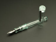 The Franklin-Christoph Model 02 Antique Glass SE, its cap off, rests on a dark surface showing its #6 silver nib.