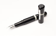 Franklin-Christoph Model 19 Fountain Pen in Black & Creme, durable acrylic, #6 silver nib, capped; on white background.