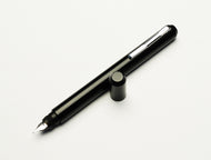 The Franklin-Christoph Model 25 Eclipse Fountain Pen rests uncapped, nib down, on a white background.