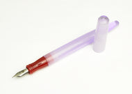 A translucent purple Franklin-Christoph Model 65 Stabilis FP - Sex & Candy pen with red grip, uncapped.