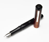 A Franklin-Christoph Model 31 Omnis Copper Rising fountain pen with #6 nib rests on a white background.