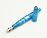 Franklin-Christoph Pocket 66 FP - Sea Blue SE with silver nib and cap lies beside another pen on a white surface.