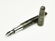 The Franklin-Christoph Pocket 66 FP - Smoke & Aluminum SE with cap off, silver nib, rests on a white background.