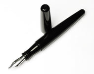 Franklin-Christoph Pocket 66 Fountain Pen - Classic Black, silver nib exposed, rests on a white surface.